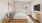 a bedroom with a bed and a television